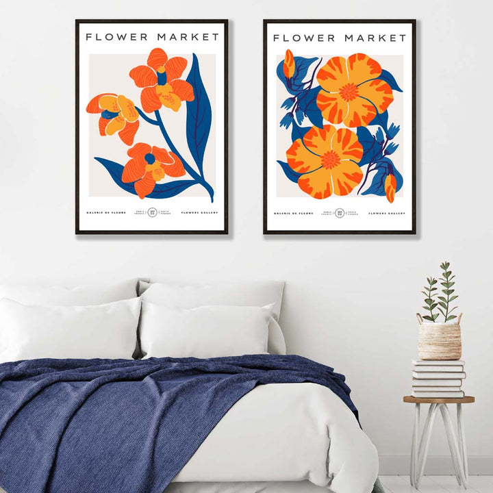 Sett med 2 kunsttrykk med motiver av et vårblomstermarked i knalloransje og blått.