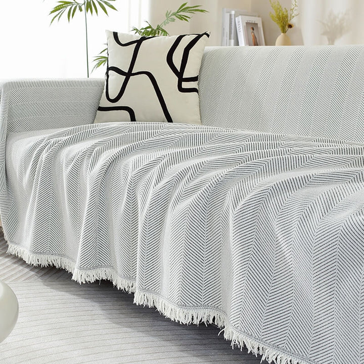 Chenille-teppe med fiskebensmønster og dusk, sofapledd