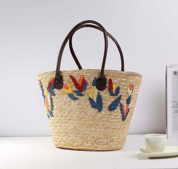 Braided beach bag with colorful embroidery pattern Skanto