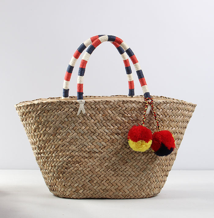 Braided beach bag with decorative pom-poms Skanto