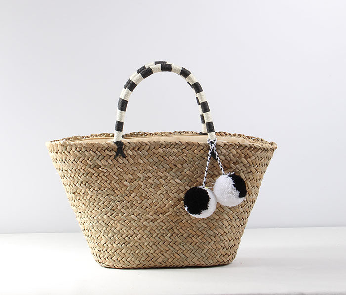 Braided beach bag with decorative pom-poms Skanto
