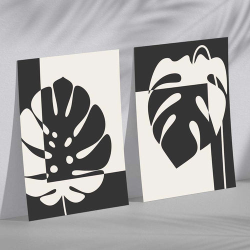 Sett med 2 innrammede kunsttrykk med Monstera-motiver i svart og beige