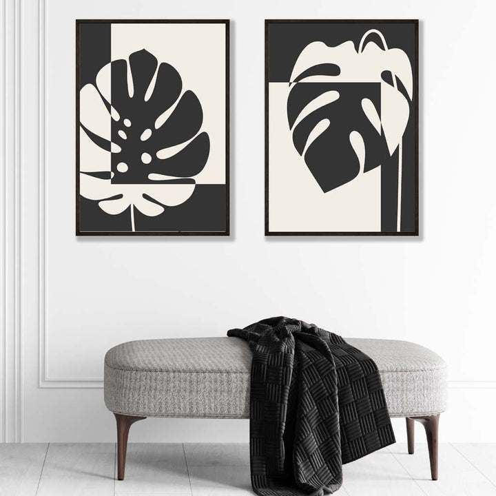 Sett med 2 innrammede kunsttrykk med Monstera-motiver i svart og beige