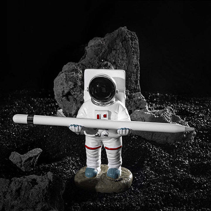 Støtte for telefoner eller penner i astronautdekorasjoner | Skanto