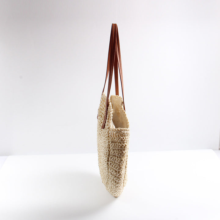 Round straw bag with elegant leather handles Skanto