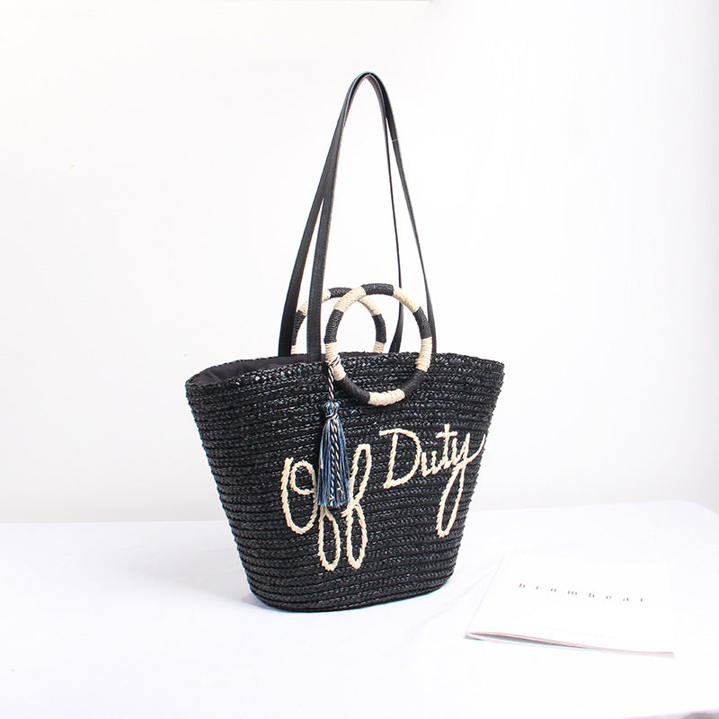 Designer Straw Bag with Playful Text and Decorative Pom Pom Skanto