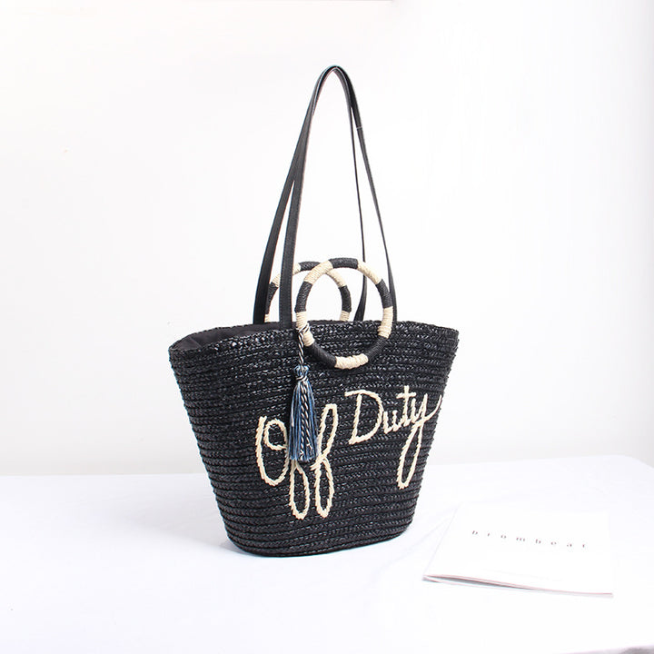 Designer Straw Bag with Playful Text and Decorative Pom Pom Skanto