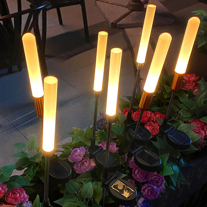 Vanntett solcelledrevet sylinderlampe laget av akryl, aluminium, rustfritt stål og ABS med LED-belysning for utendørs bruk og hagedesign.