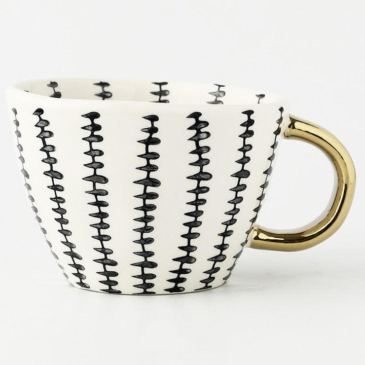 Skanto | Cup med abstrakt geometrisk mønster og gullhåndtak