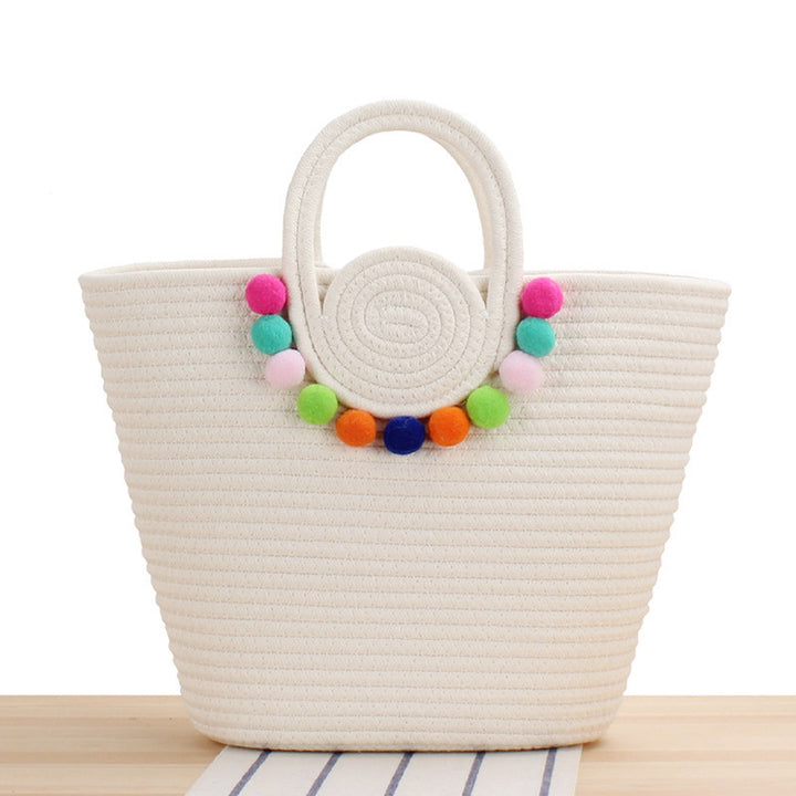 Modern handbag with playful pom-pom embellishments Skanto