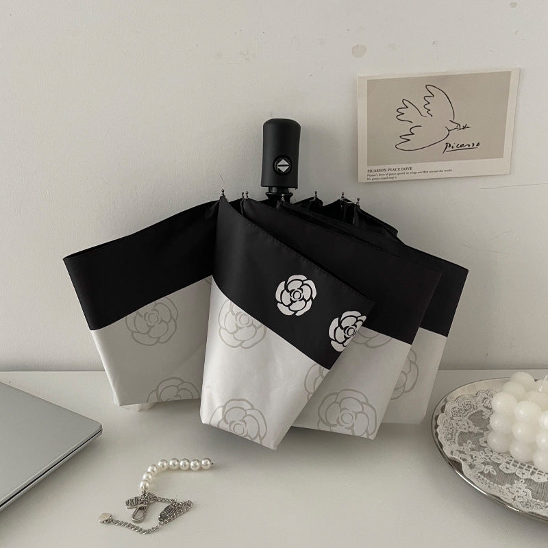 Dame elegant paraply med stilfullt blomsterdesign Skanto