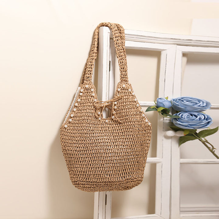 Handbag with pearl embellishments and innovative closure Skanto