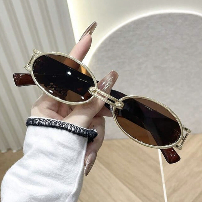Women's oval sunglasses with golden accents and stylish frame Skanto