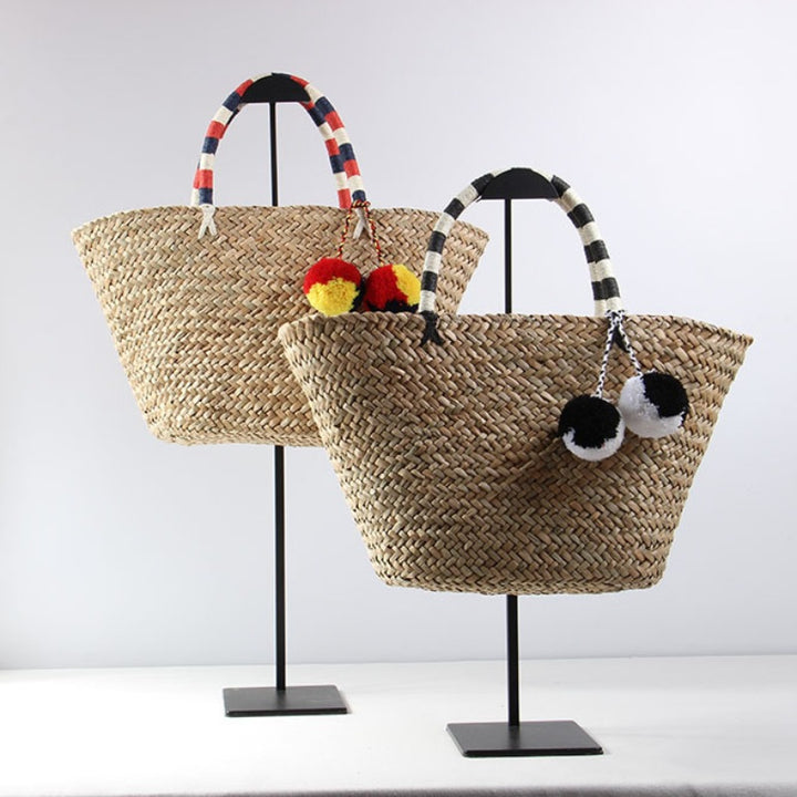 Braided beach bag with decorative pom-poms Skanto