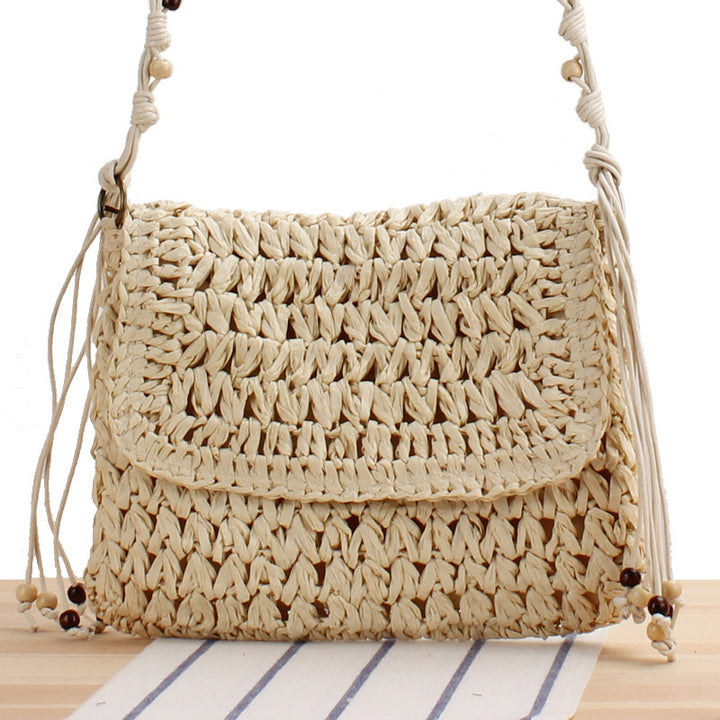 Woven natural material handbag with playful fringes Skanto