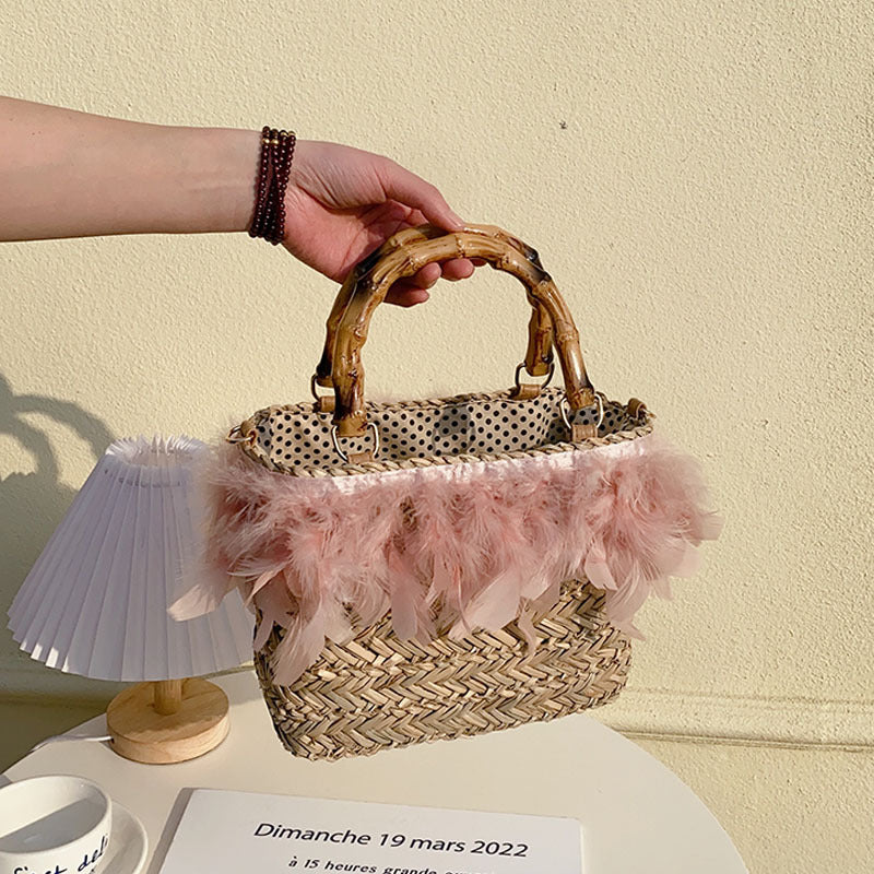 Elegant handbag with feathers and bamboo handle Skanto
