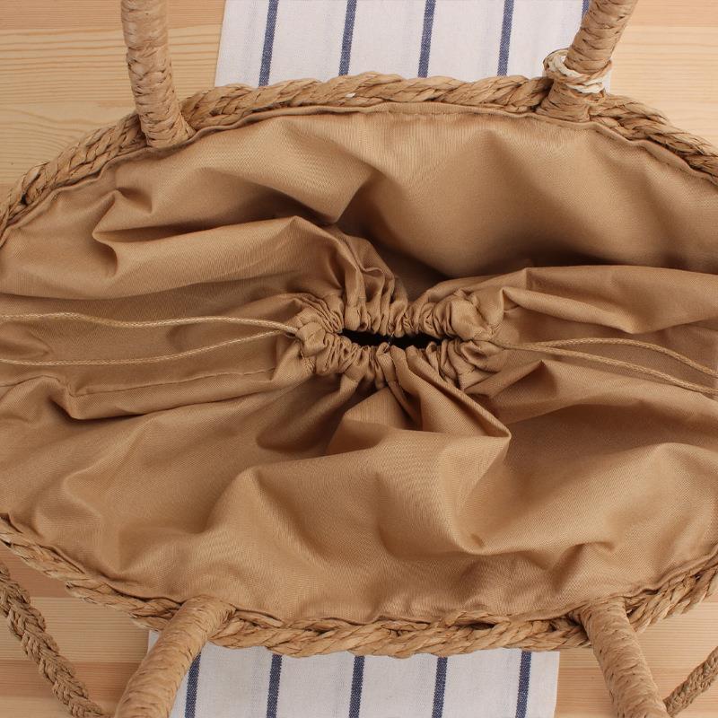 Handbag made of braided natural material with elegant fringe detail Skanto