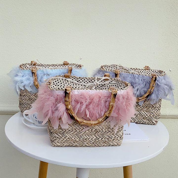 Elegant handbag with feathers and bamboo handle Skanto