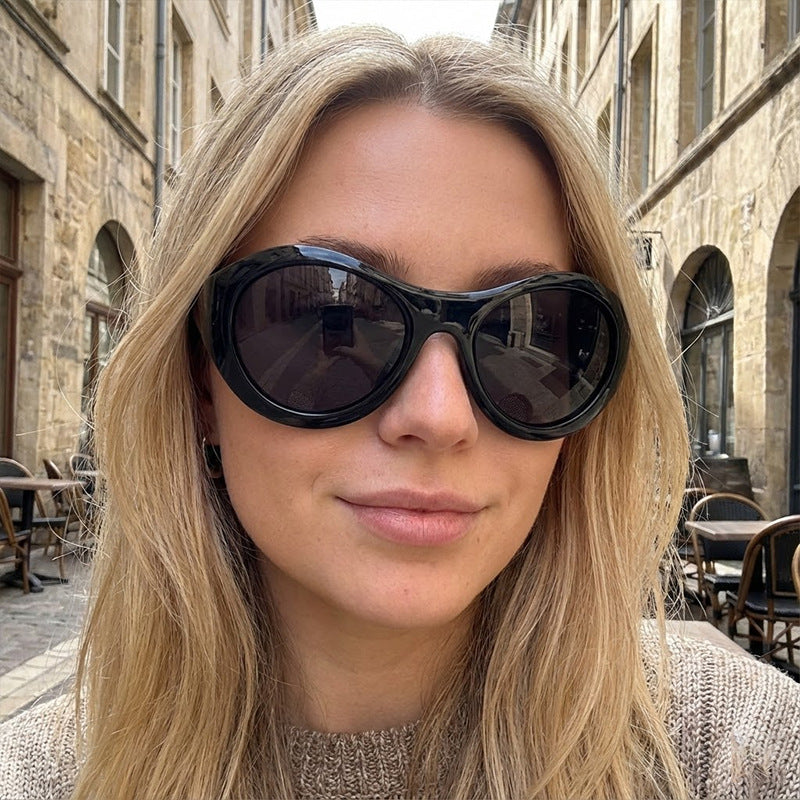 Dame Mote Oval Solbrille med gjennomsiktig ramme Skanto