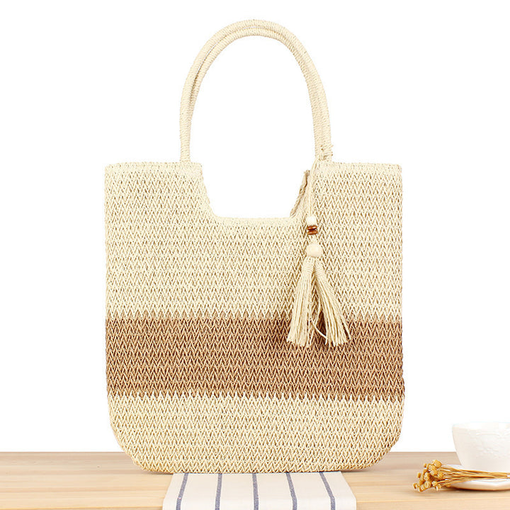 Modern beach tote bag made of woven natural material with fringed details Skanto