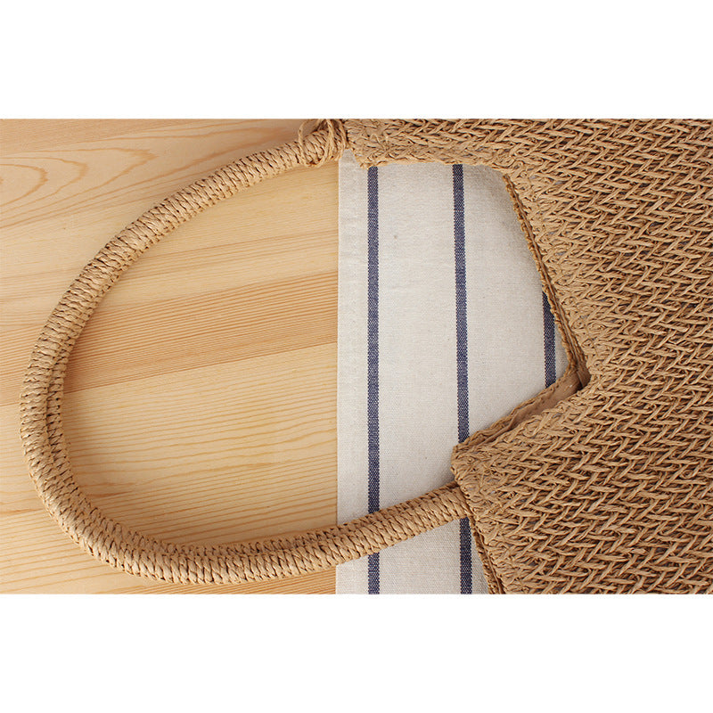 Modern beach tote bag made of woven natural material with fringed details Skanto
