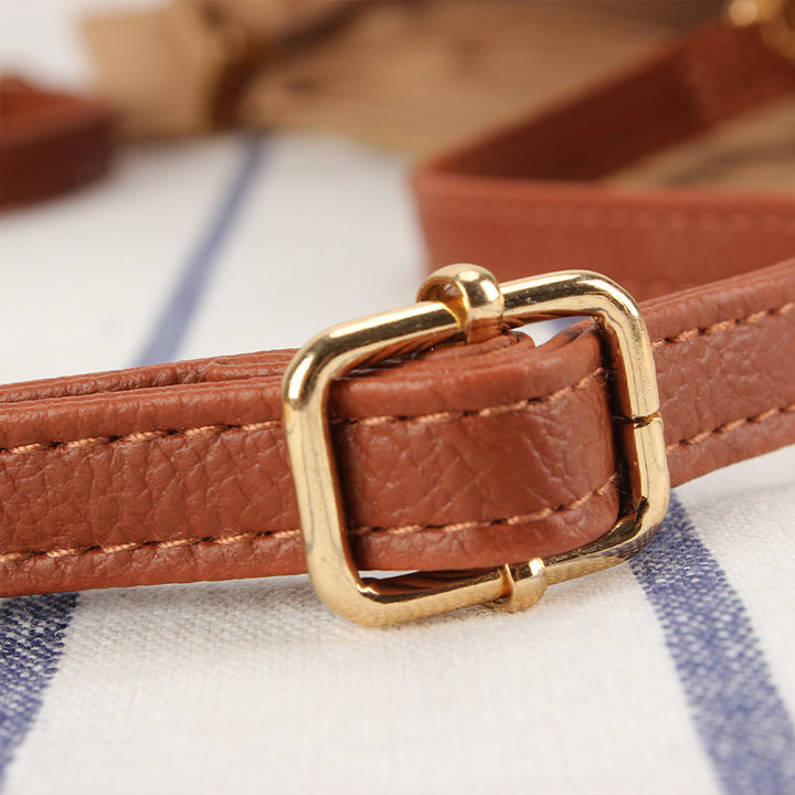 Crossbody bag made of braided natural material with contrasting stripes Skanto