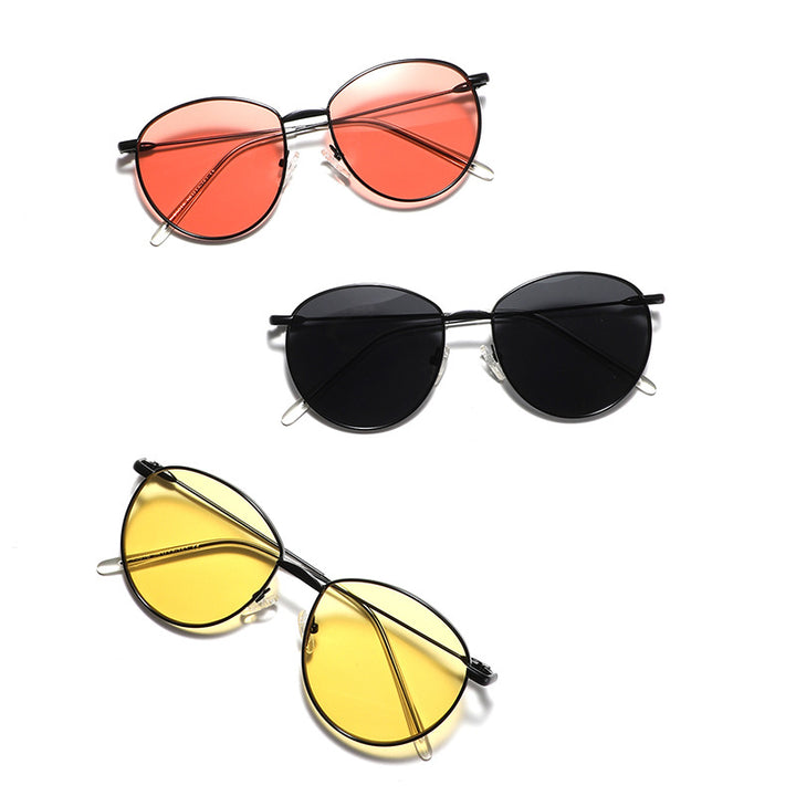 Dame rund solbrille med smal metallramme og polariserte linser Skanto