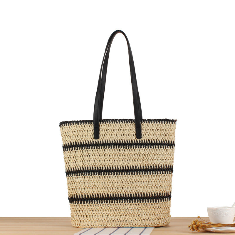 Modern beach bag made of woven natural material with elegant handles Skanto
