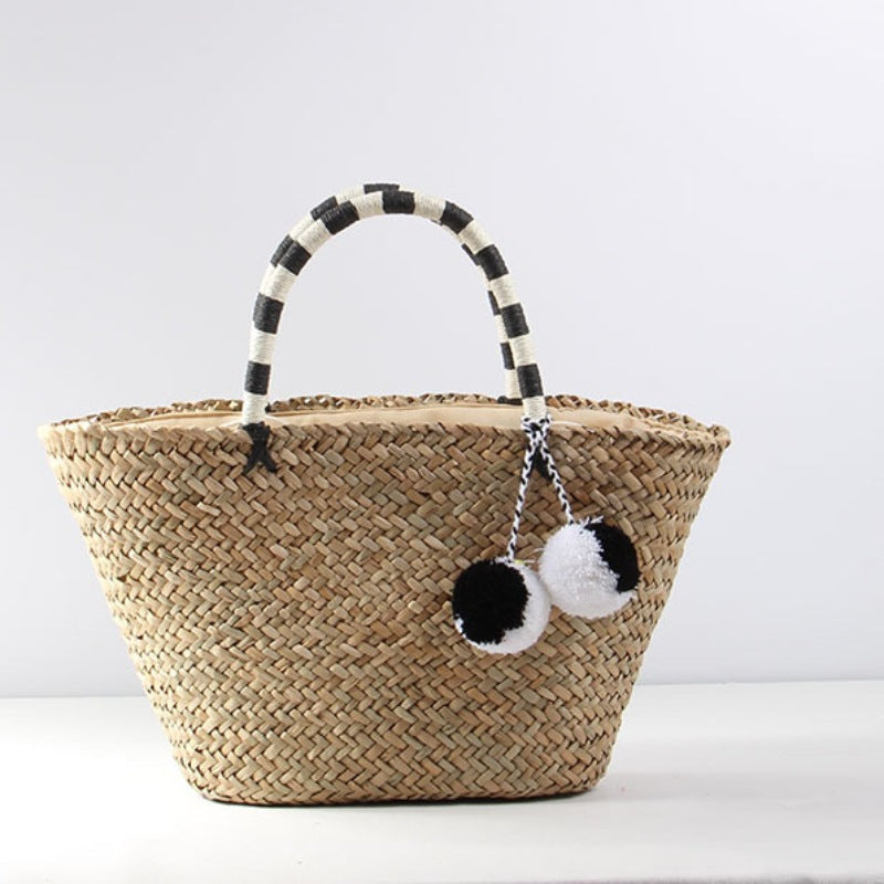 Braided beach bag with decorative pom-poms Skanto