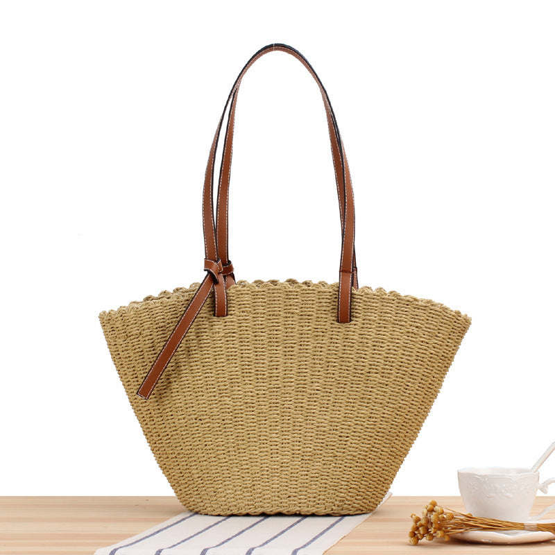 Woven natural material handbag with elegant leather handles Skanto