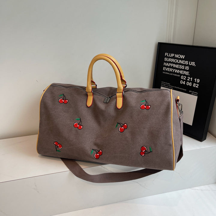 Sporty weekend bag with playful cherry pattern Skanto