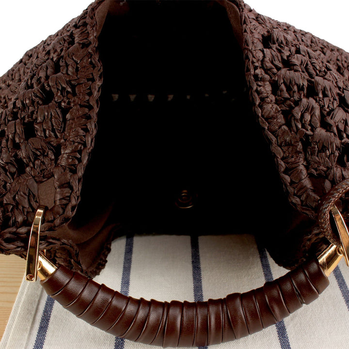 Handbag made of artisanal natural material with unique tassel pendant Skanto