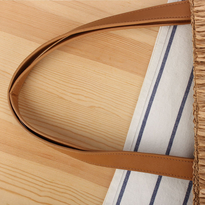 Beach bag made of hand-woven natural material with fringe detail Skanto