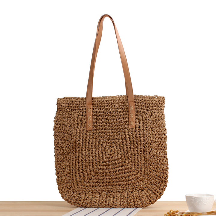 Bag made of braided natural material with soft leather handles Skanto