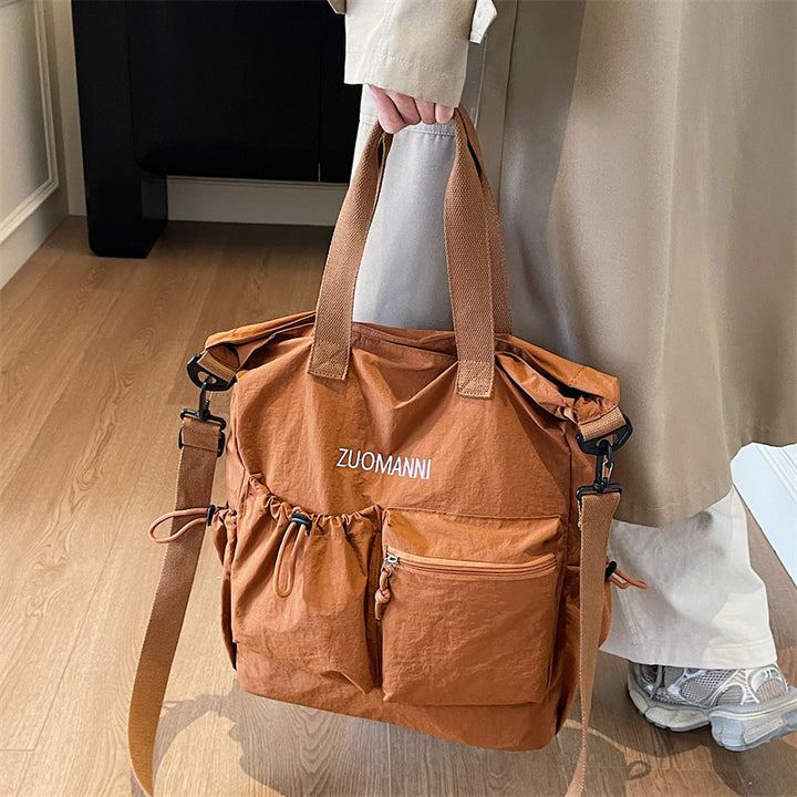 Trillebag med multifunksjonelle ytterlommer og justerbar skulderstropp Skanto