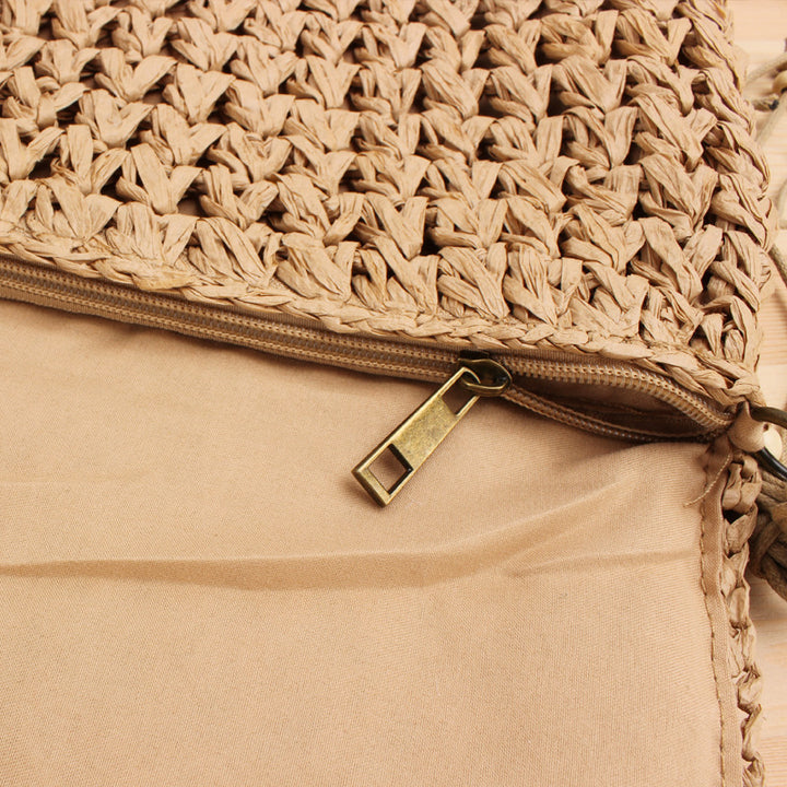 Woven natural material handbag with playful fringes Skanto