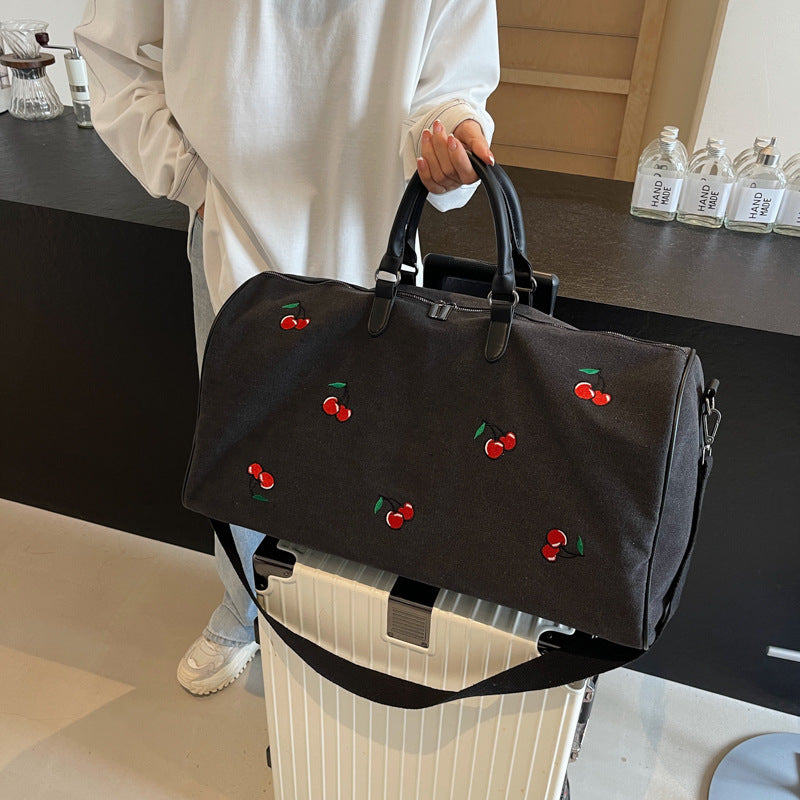 Sporty weekend bag with playful cherry pattern Skanto