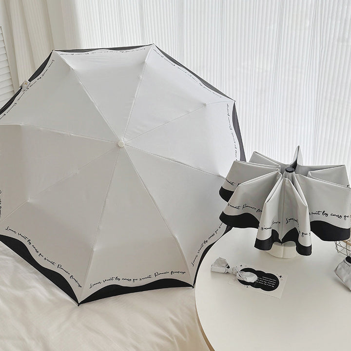 Dame sammenleggbar paraply med stilfull design og praktisk lagringssystem Skanto