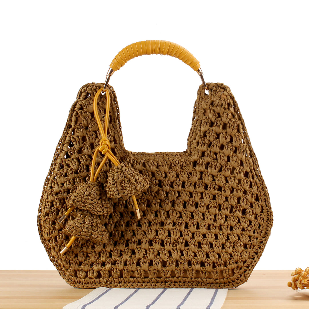 Handbag made of artisanal natural material with unique tassel pendant Skanto