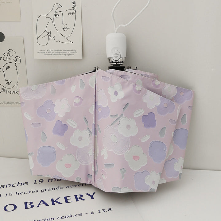 Dame sammenleggbar paraply med stilfullt blomstedesign Skanto