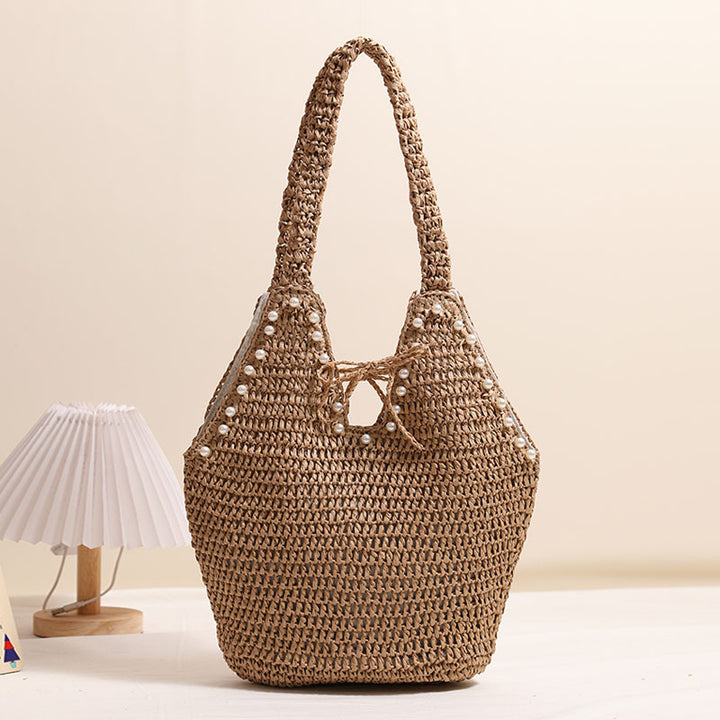 Handbag with pearl embellishments and innovative closure Skanto