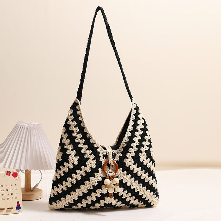 Handmade macrame shoulder bag with playful pendant Skanto