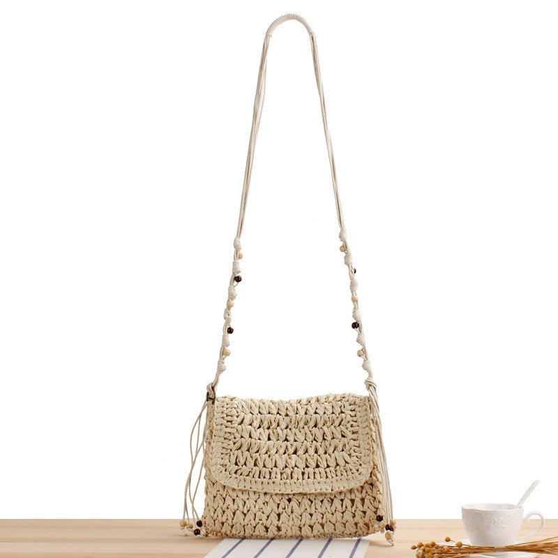 Woven natural material handbag with playful fringes Skanto