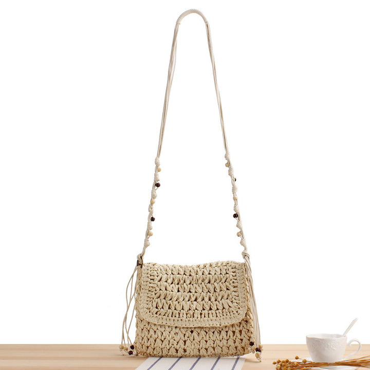 Woven natural material handbag with playful fringes Skanto