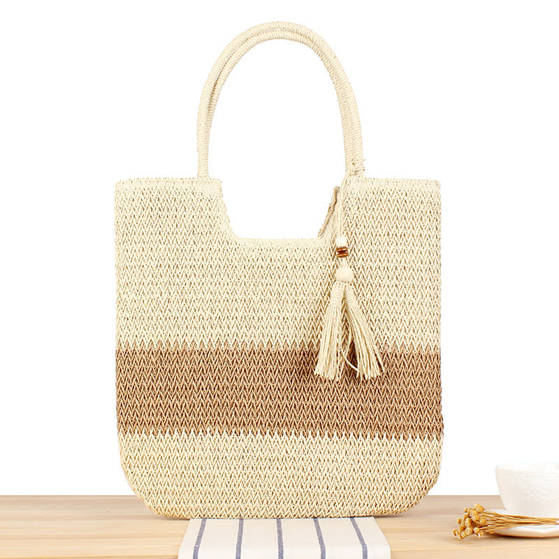 Modern beach tote bag made of woven natural material with fringed details Skanto