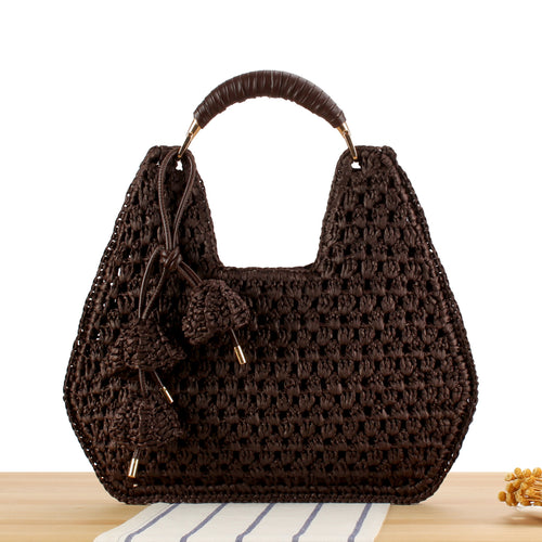 Handbag made of artisanal natural material with unique tassel pendant Skanto