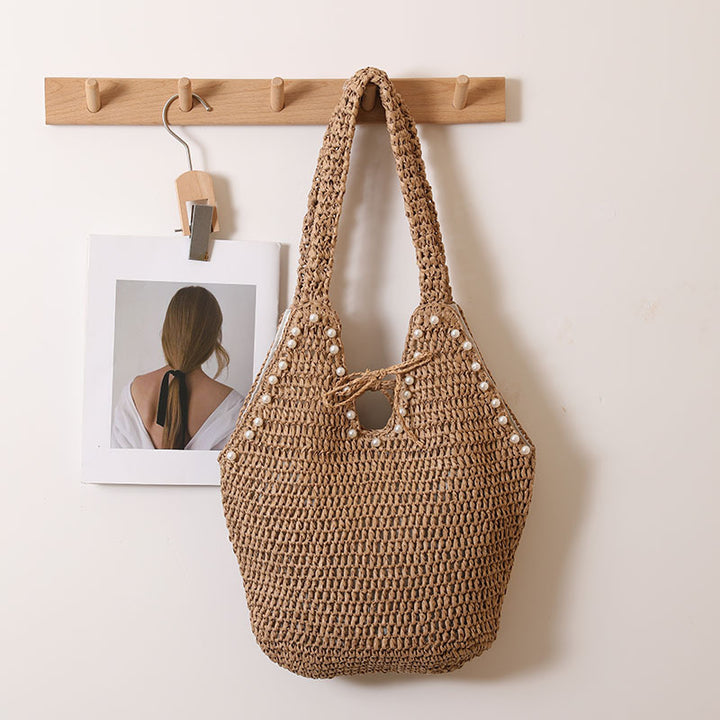 Handbag with pearl embellishments and innovative closure Skanto