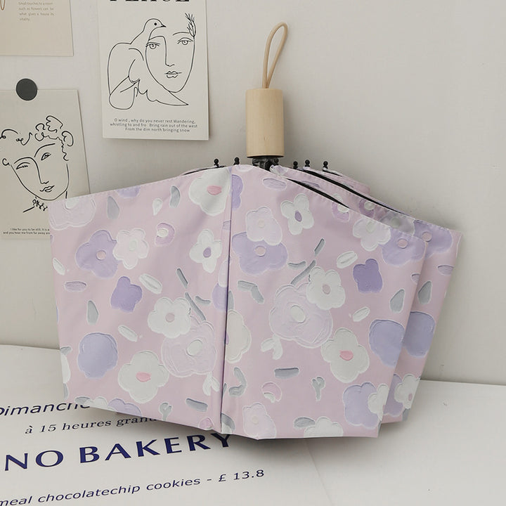 Dame sammenleggbar paraply med stilfullt blomstedesign Skanto