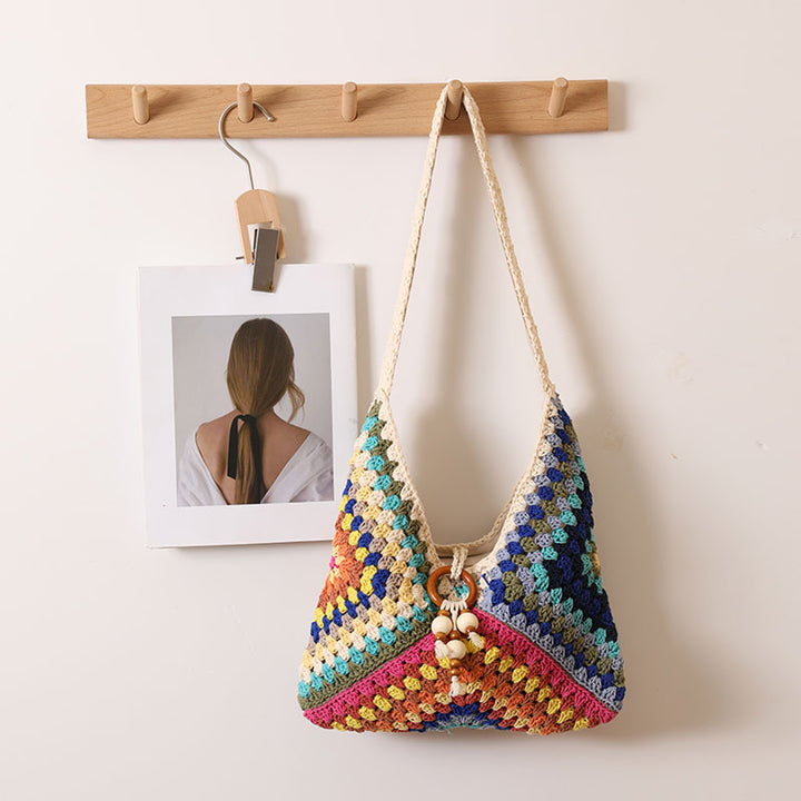 Handmade macrame shoulder bag with playful pendant Skanto