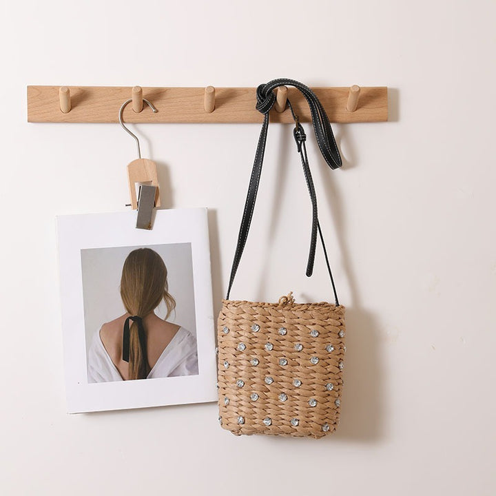 Woven natural material handbag with sparkling applications Skanto